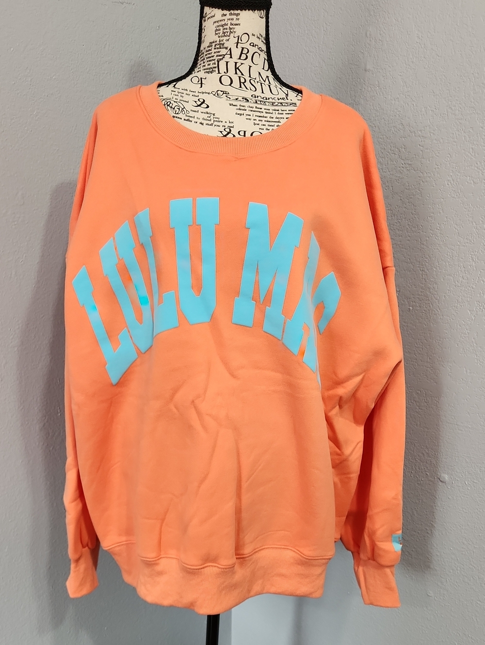 Lulu Mac Coral Orange Sweatshirt with Aqua Lettering.